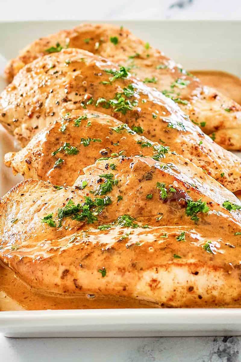 closeup of chicken dijon and sauce on a platter.