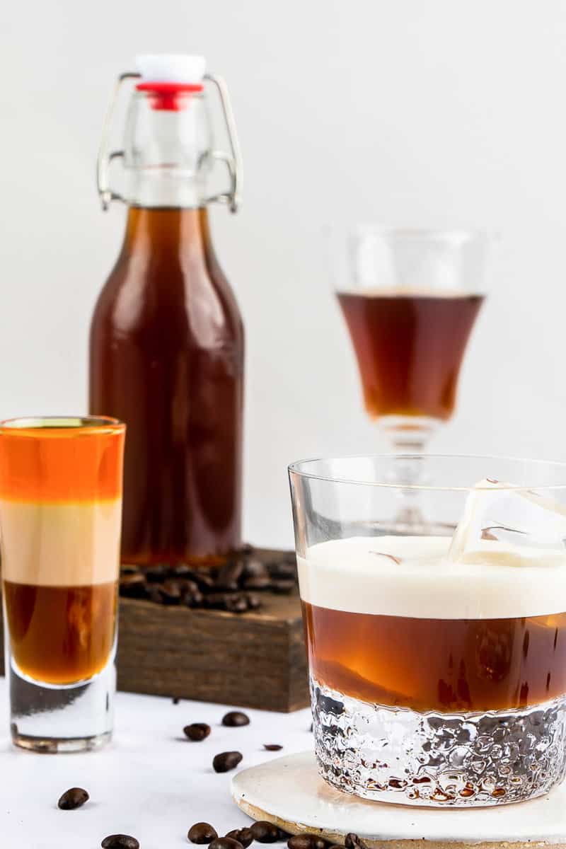 homemade Kahlua coffee liqueur in a bottle and drinks made with it.