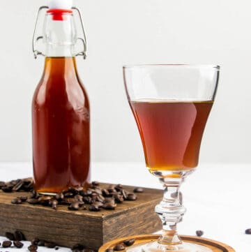 homemade Kahlua coffee liqueur in a glass and bottle.