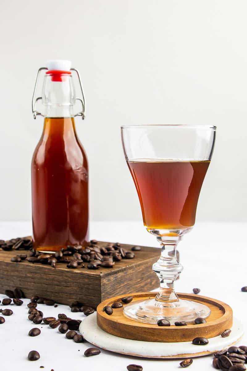 homemade Kahlua coffee liqueur in a glass and bottle.