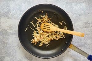 cooked hashbrowns in a skillet.