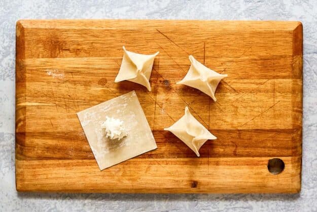 folding and shaping cream cheese rangoon.