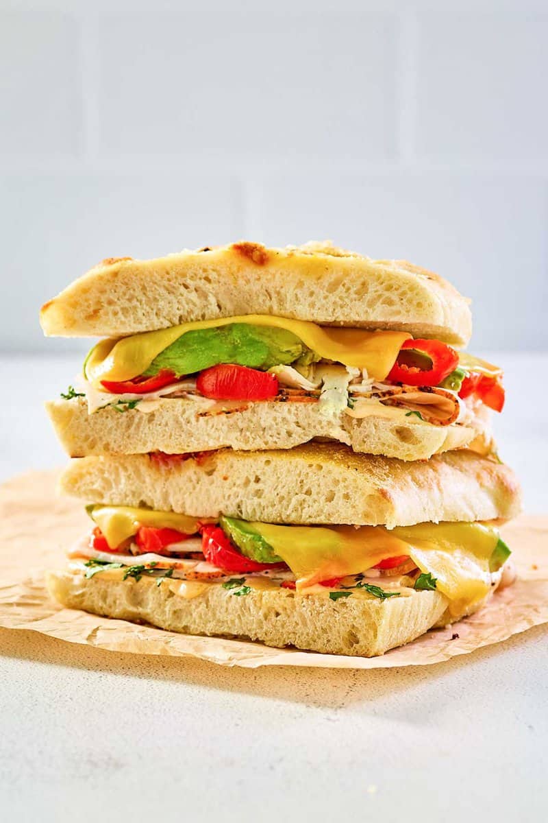 copycat Panera chipotle chicken avocado melt on parchment paper.