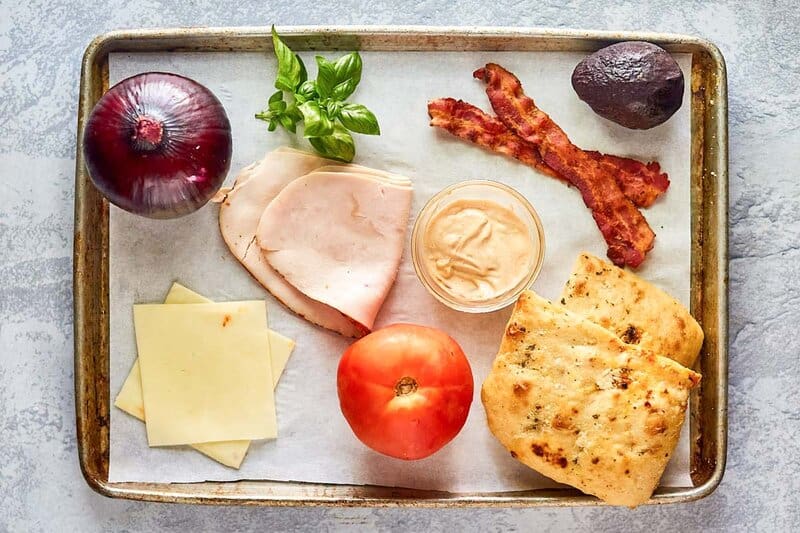 Panera frontega yellow sandwich ingredients on a tray.