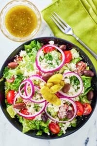 overhead view of copycat Panera Greek salad and dressing.