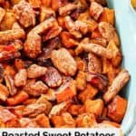 closeup of roasted sweet potatoes topped with candied pecans.