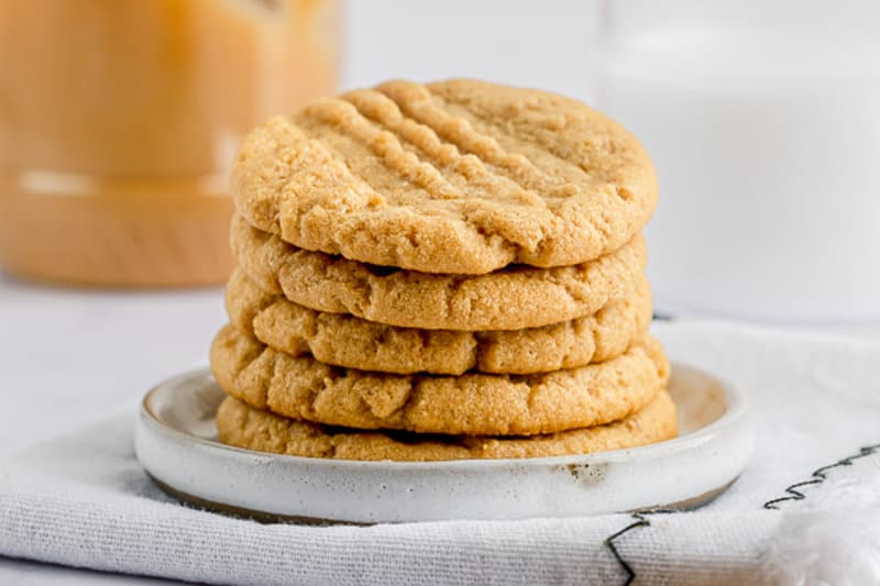five homemade 3 ingredient peanut butter cookies on a plate.