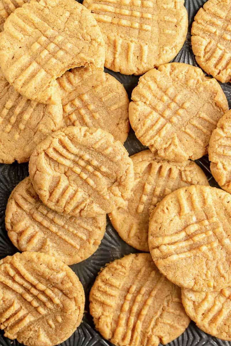 homemade 3 ingredient peanut butter cookies scattered on a platter.