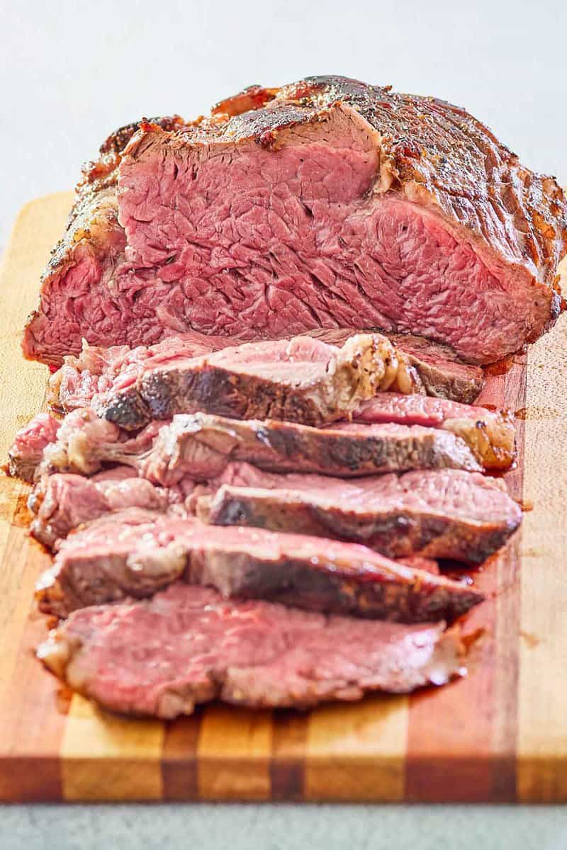 beef tenderloin roast on a wood cutting board.