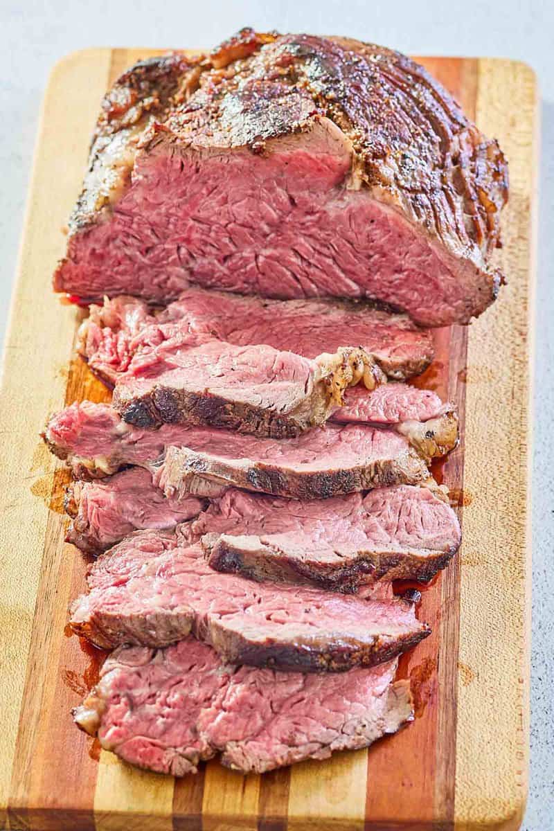 beef tenderloin roast and slices on a cutting board.