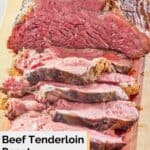 partially sliced beef tenderloin roast on a cutting board.