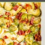 Brussels sprouts au gratin with bacon in a baking dish.