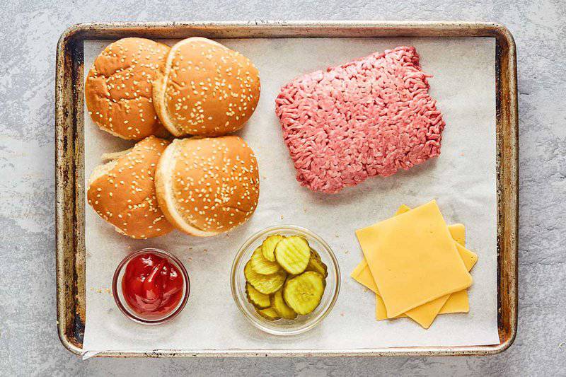 Burger King cheeseburger ingredients on a tray.