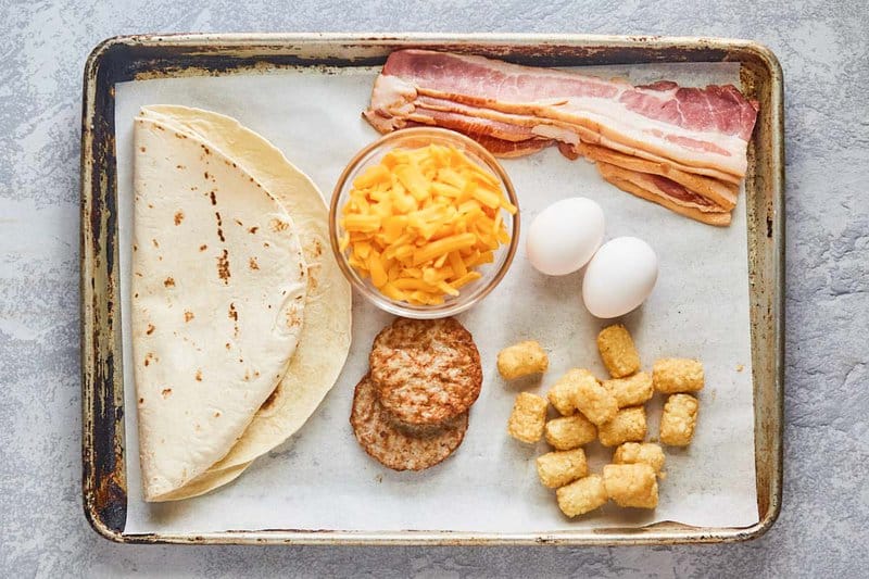 Burger King egg-normous breakfast burrito ingredients on a tray.