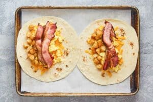 two homemade Burger King egg-normous breakfast burritos before rolling up.