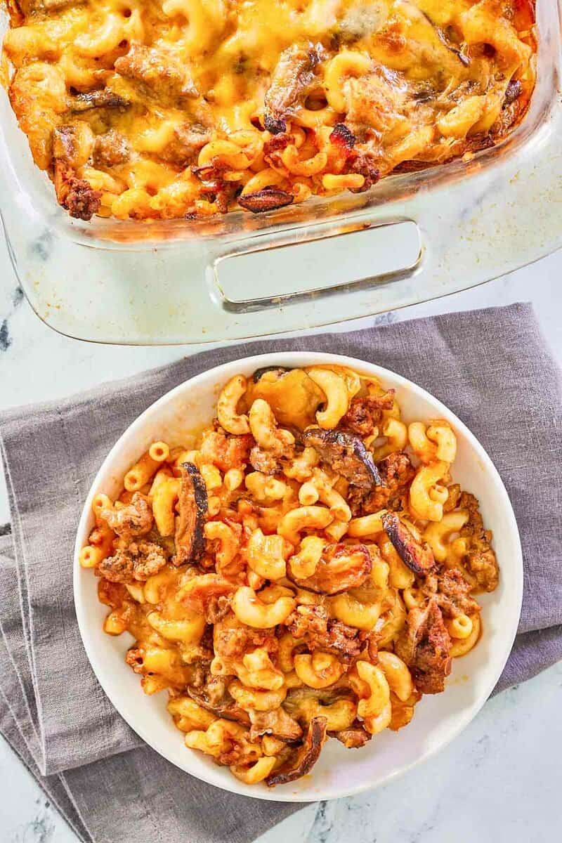 overhead view of cheeseburger casserole in a baking dish and on a plate.