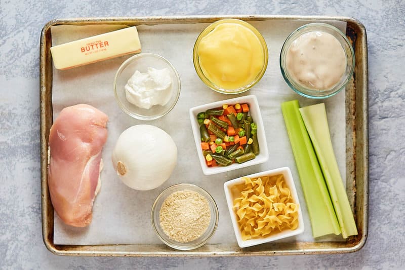 chicken noodle casserole ingredients on a tray.