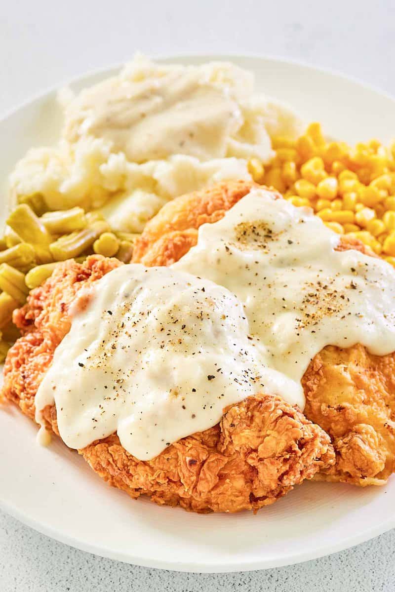 copycat Cracker Barrel chicken fried chicken with gravy on a plate.