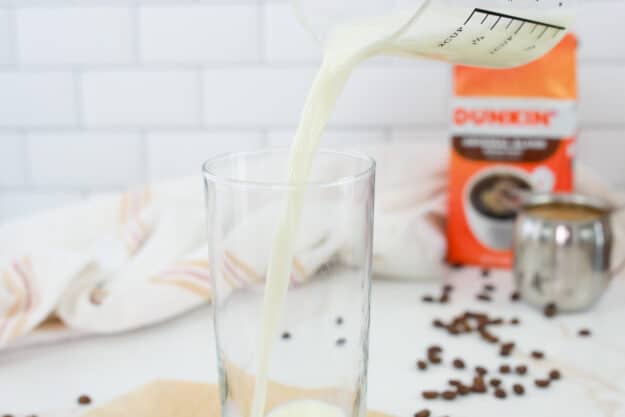 pouring milk into a glass.