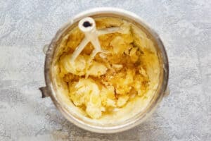 Pineapple buttercream frosting ingredients in a mixing bowl.