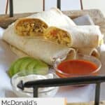 homemade McDonald's sausage breakfast burrito on a tray with sauces.
