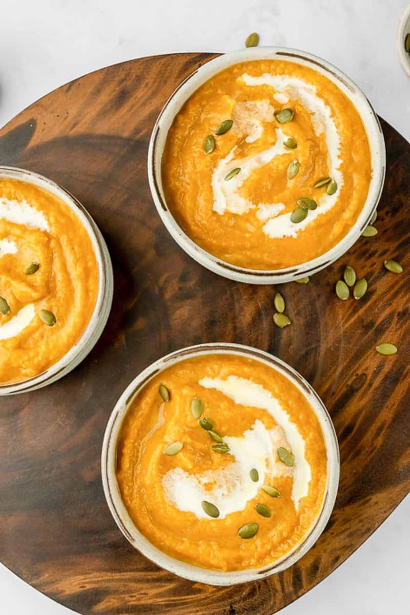 overhead view of copycat Panera autumn squash soup in three bowls.