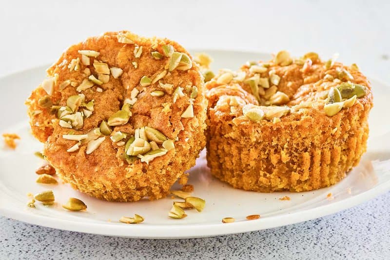 two copycat Starbucks pumpkin cream cheese muffins on a plate.