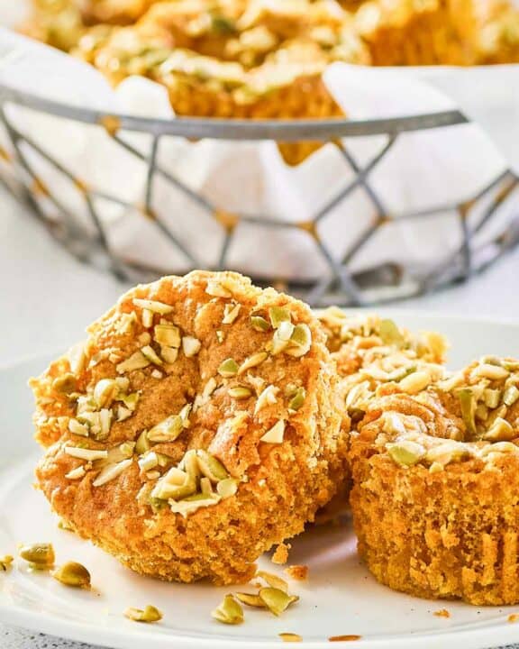 copycat Starbucks pumpkin cream cheese muffins on a plate and in a basket.