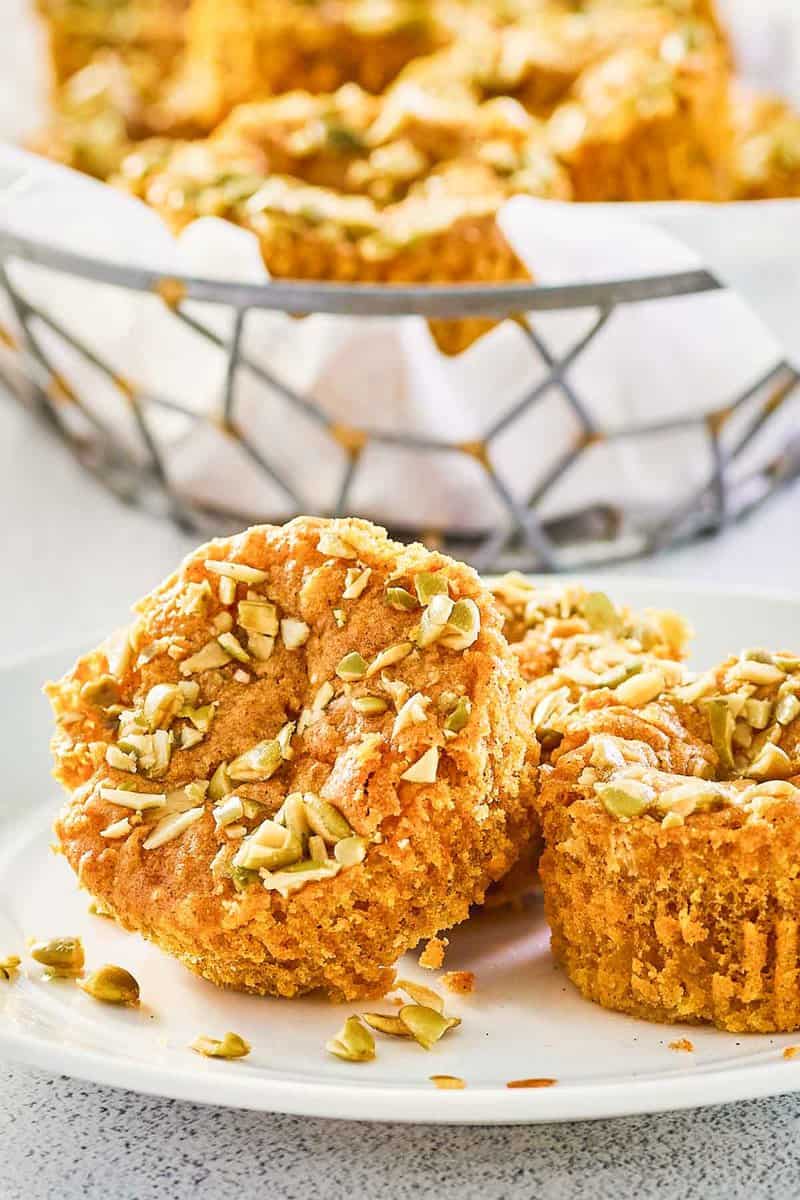 copycat Starbucks pumpkin cream cheese muffins on a plate and in a basket.