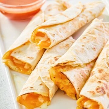 five copycat Taco Bell cheesy roll ups on a platter.