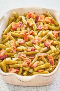 copycat Texas Roadhouse green beans with bacon and onions in a serving dish.