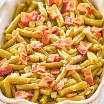 copycat Texas Roadhouse green beans with bacon and onions in a serving dish.