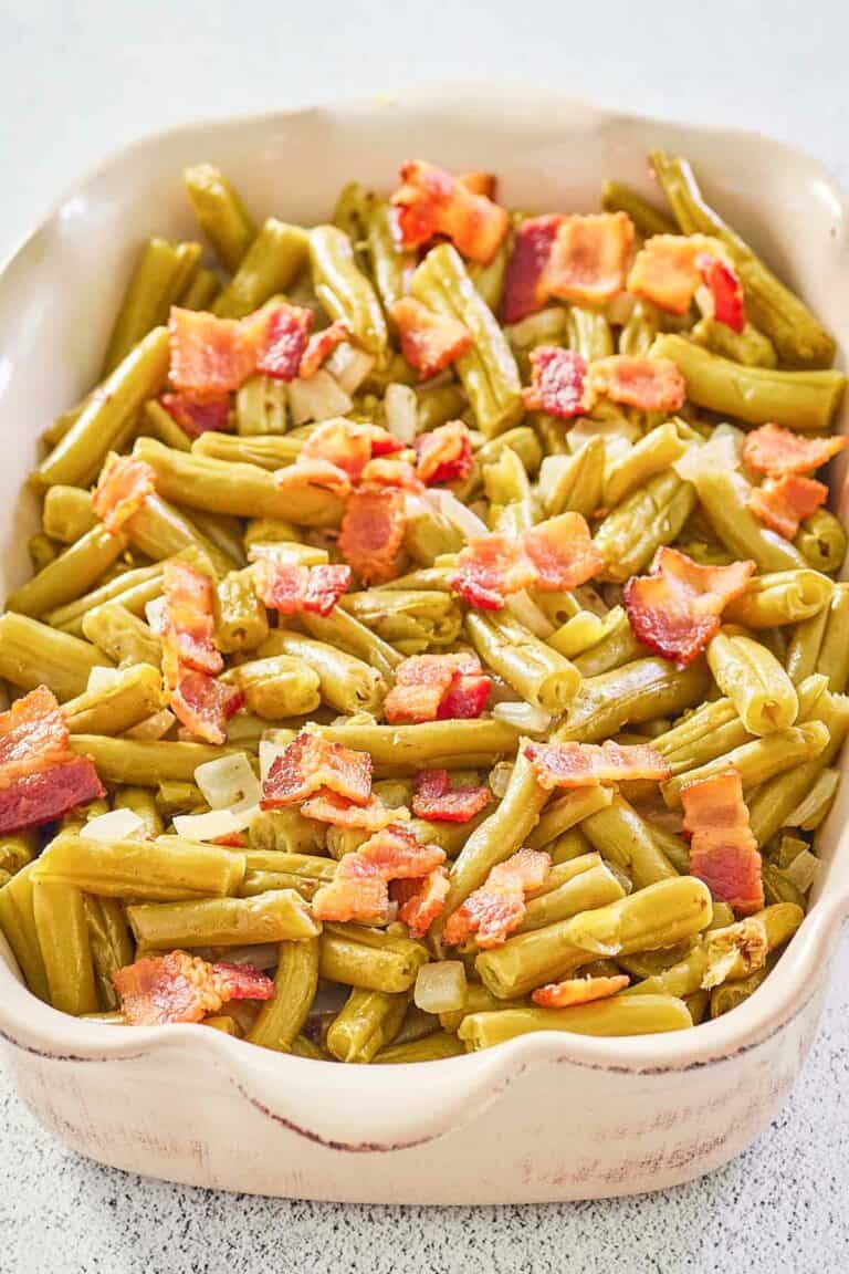 copycat Texas Roadhouse green beans with bacon and onions in a serving dish.