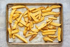 cooked French fries on a tray.