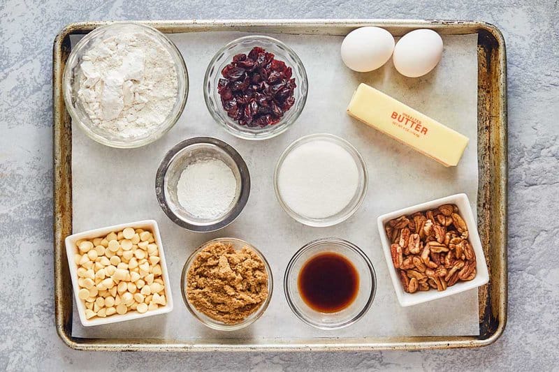 white chocolate cranberry cookies ingredients on a tray.