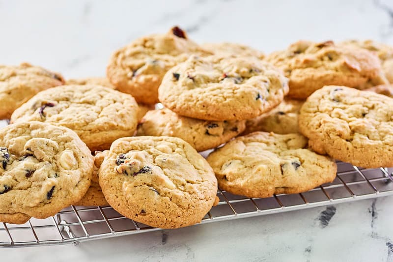 white chocolate cranberry cookies on a wire rack.