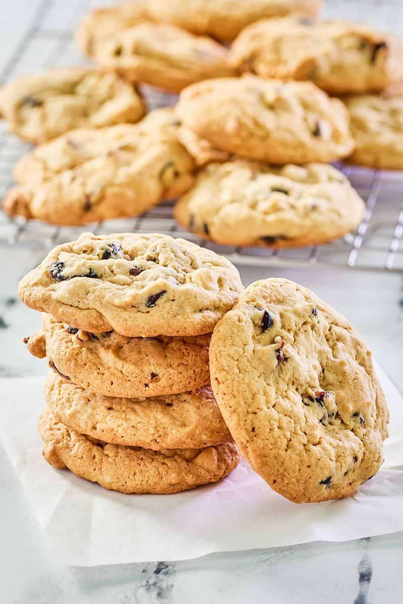 white chocolate cranberry cookies on parchment paper and a wire rack.