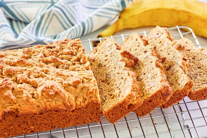 whole wheat banana bread and a banana next to it.