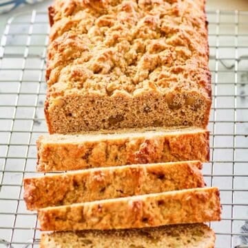 whole wheat banana nut bread slices on a wire rack.