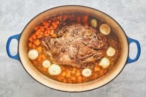 Yankee pot roast ingredients in a Dutch oven.