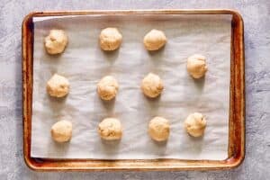 homemade dumplings on a baking sheet.