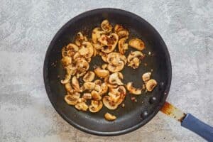 cooked mushroom slices in a skillet.