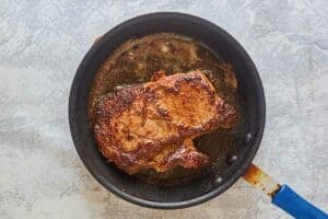 cooked steak in a skillet.