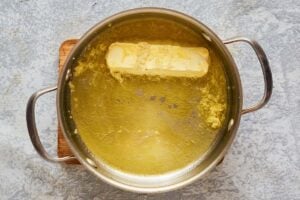 melting margarine with garlic in a pan.