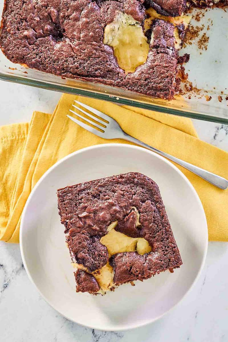 overhead view of earthquake cake in a baking dish and a slice on a plate.