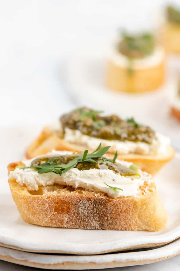 two goat cheese crostini canapes with pesto.