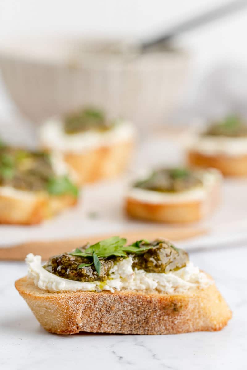 side of a goat cheese pesto crostini canape.