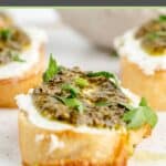 close up of a goat cheese canape with pesto.