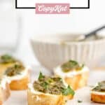 several goat cheese pesto crostini canapes on a tray.