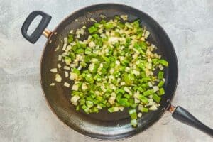 chopped bell pepper and onions in a skillet.